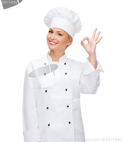 Image of smiling female chef showing ok hand sign