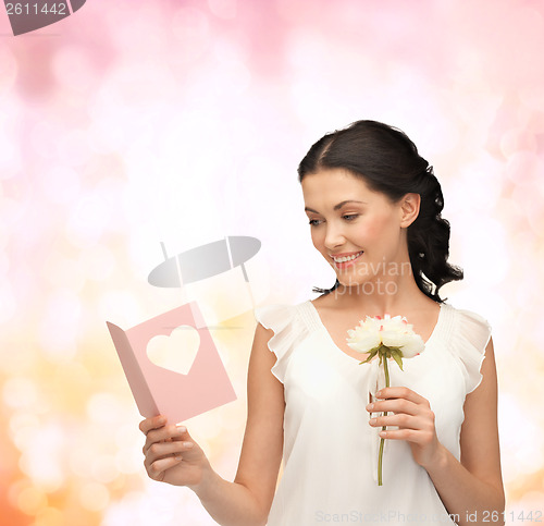 Image of young woman holding flower and postcard