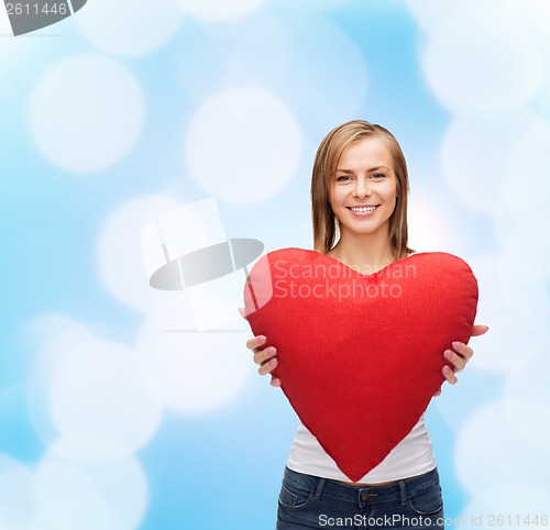 Image of smiling woman in white t-shirt with heart