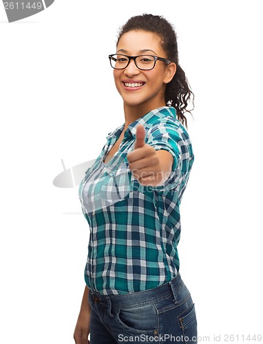 Image of smiling girl in eyeglasses showing thumbs up