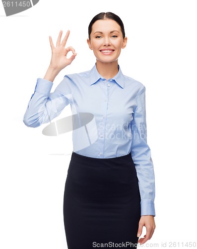 Image of smiling businesswoman showing ok sign
