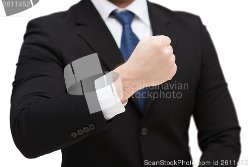 Image of businessman showing something at his hand