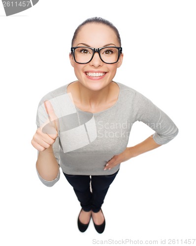 Image of asian woman in eyeglasses showing thumbs up