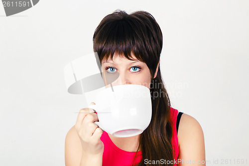 Image of Young girl with a huge mug