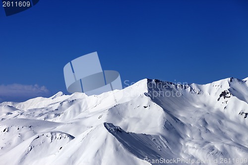 Image of View on off-piste snowy slope at sunny day