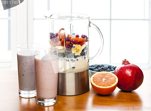 Image of Making smoothies in blender with fruit and yogurt