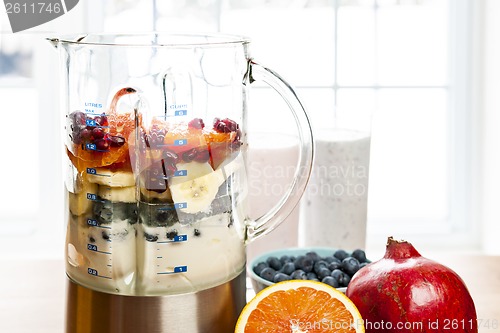 Image of Making smoothies in blender with fruit and yogurt