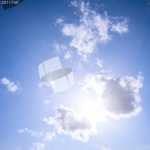 Image of Blue sky with sun and clouds