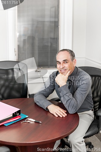 Image of Businessman sitting in office meeting room