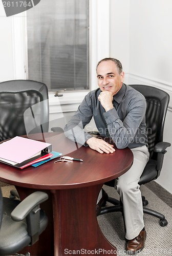 Image of Businessman sitting in office meeting room