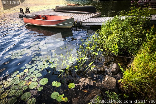 Image of Rowboat at lake shore at dusk