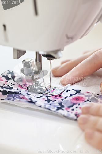 Image of Hands with sewing machine