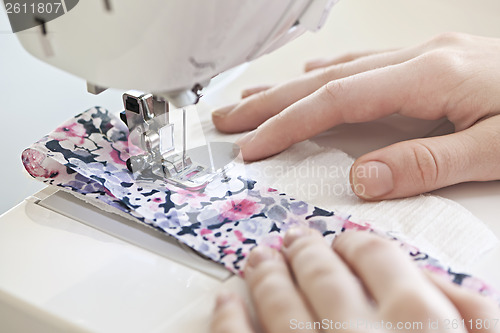 Image of Hands with sewing machine