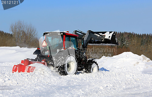 Image of Tractor Plowing Snow on a Yard