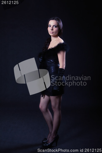 Image of Young woman in a leather black dress