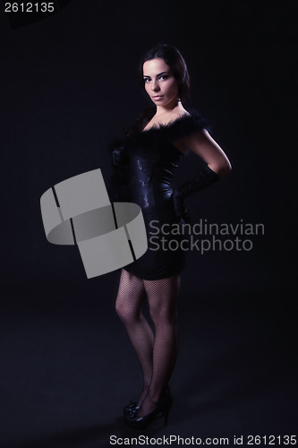 Image of Young woman in a leather black dress