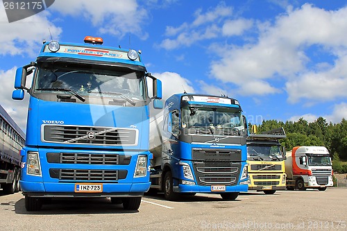 Image of Four Trucks on a Yard