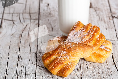 Image of glass of milk and two fresh baked buns 