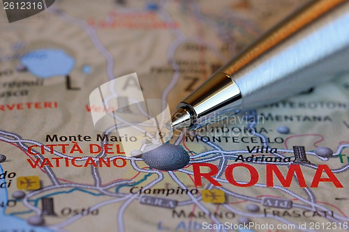 Image of Pen Pointing at Rome on the Map