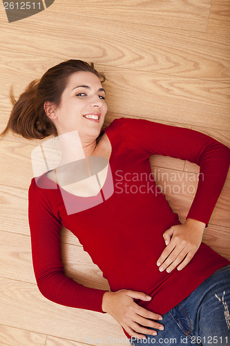 Image of Woman lying on the floor and smiling