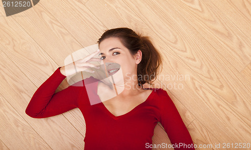 Image of Woman lying on the floor and smiling