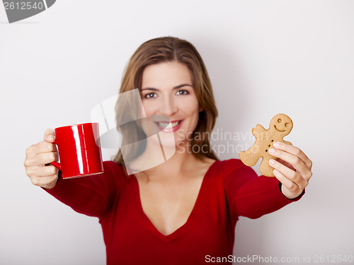 Image of Woman drinking coffee with cookies