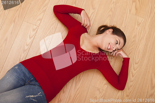 Image of Happy woman on the floor