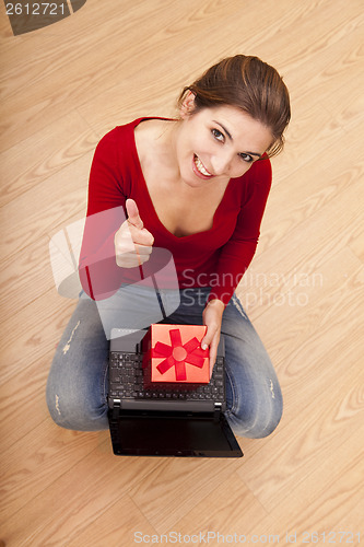 Image of Woman on the floor with a present