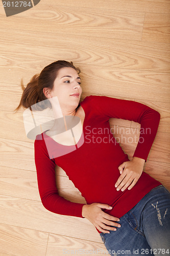 Image of Woman lying on the floor and thinking
