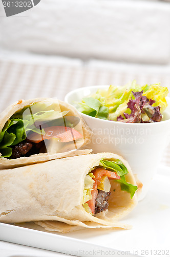 Image of kafta shawarma chicken pita wrap roll sandwich