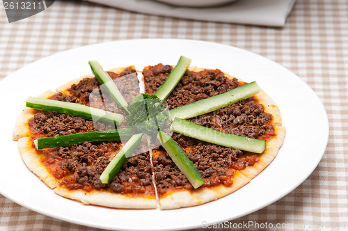 Image of Turkish beef pizza with cucumber on top