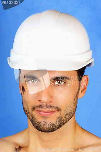 Image of Dirty manual worker with hard hat