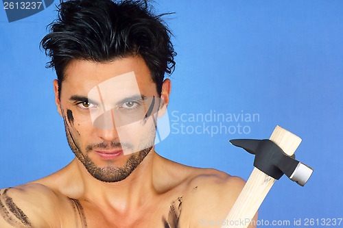 Image of Dirty manual worker with hammer