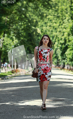 Image of Young Woman Walking in a Park