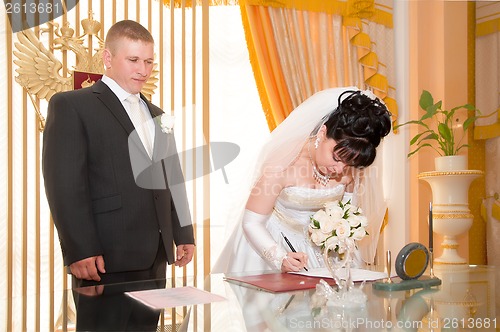 Image of Pretty pair signing document of marriage