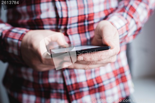 Image of The man uses a tablet PC. Modern gadget in hand.