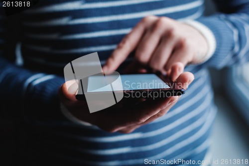 Image of The man uses a tablet PC. Modern gadget in hand.