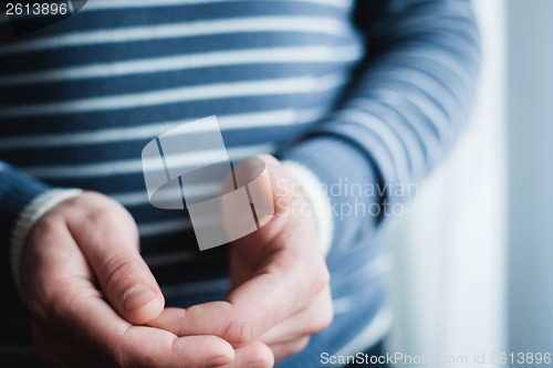 Image of The man is using a smartphone. Modern mobile phone in hand.