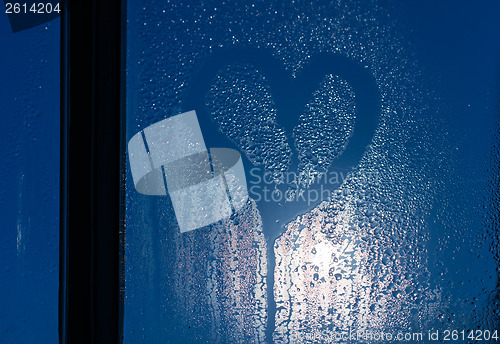 Image of Moonlight through the window. Sweaty glass and heart