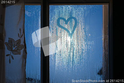 Image of Moonlight through the window. Sweaty glass and heart