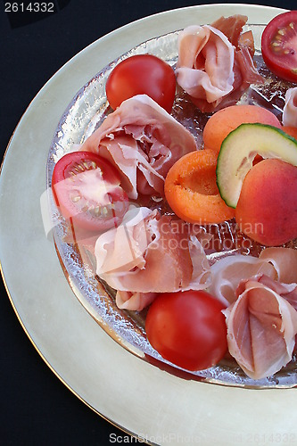 Image of Serrano ham and fruits