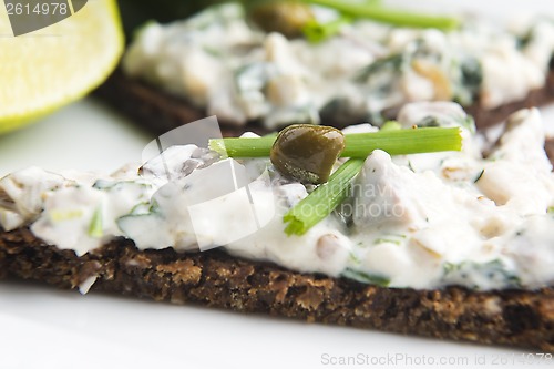 Image of sandwiches with dark bread, herrings, mushrooms, pepper