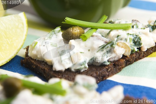 Image of sandwiches with dark bread, herrings, mushrooms, pepper