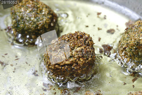 Image of Falafel balls frying in the pan