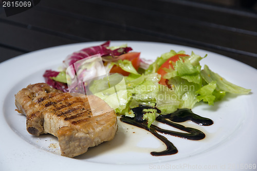 Image of Steak with salad on the table