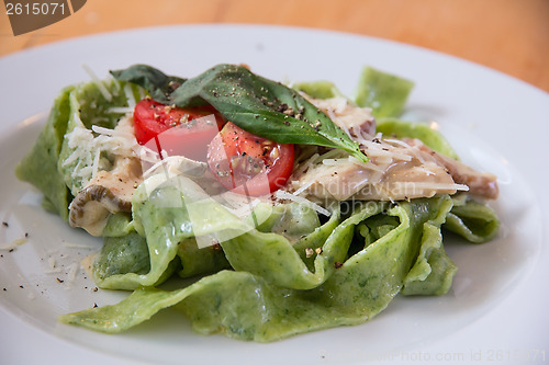 Image of Italian pasta with  spinach and tomatoes
