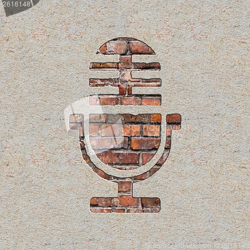 Image of Microphone Icon on the Wall.