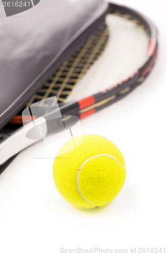 Image of tennis ball and racket on a white background