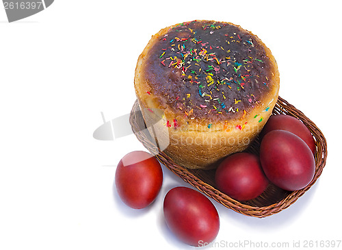 Image of Red Easter eggs and Easter bread in a basket on a white backgrou