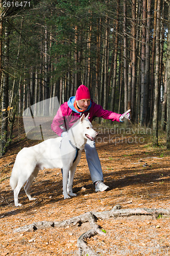 Image of The woman with a dog in a forest park